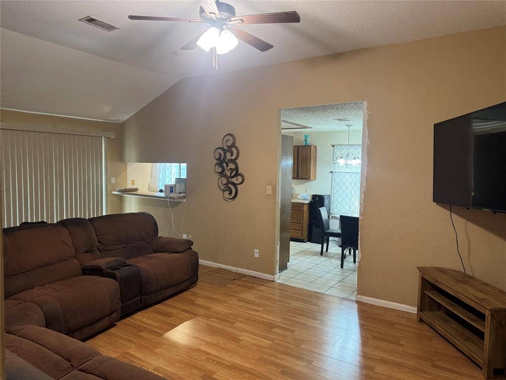 2681 Steppington Street, Grand Prairie, TX 75052 Vaulted ceilings with a ceiling fan, carpeted flooring, and window treatments