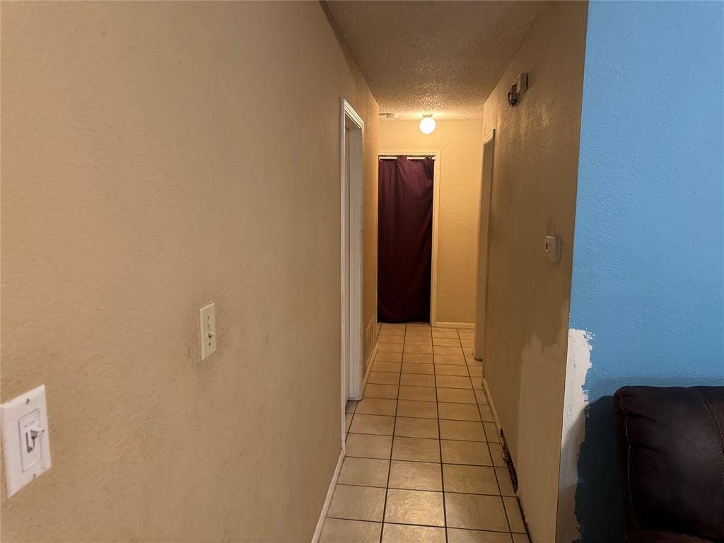 2681 Steppington Street, Grand Prairie, TX 75052 Built-in closet with sliding door, wood-finish bed frame, permanent lighting fixture, and ceiling fan