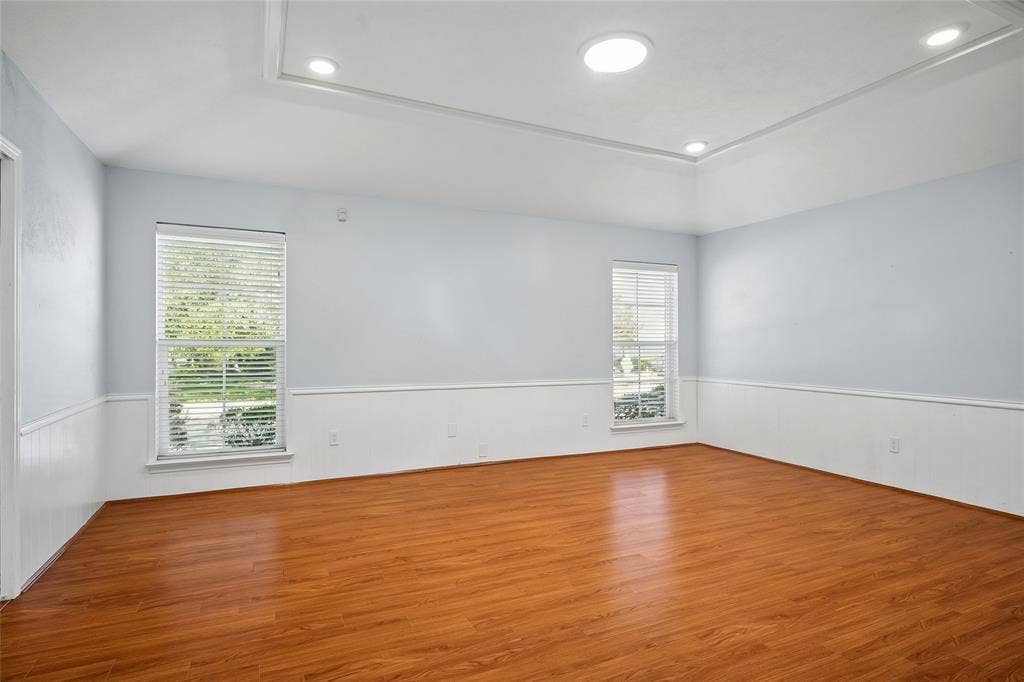 Spacious family room has a pocket door opening  to the kitchen.  Solar tubes are in both living areas, the hall, and bathrooms.