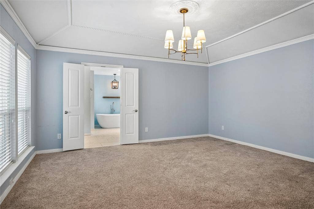 The spacious primary bedroom opens to a beautifully remodeled bath.