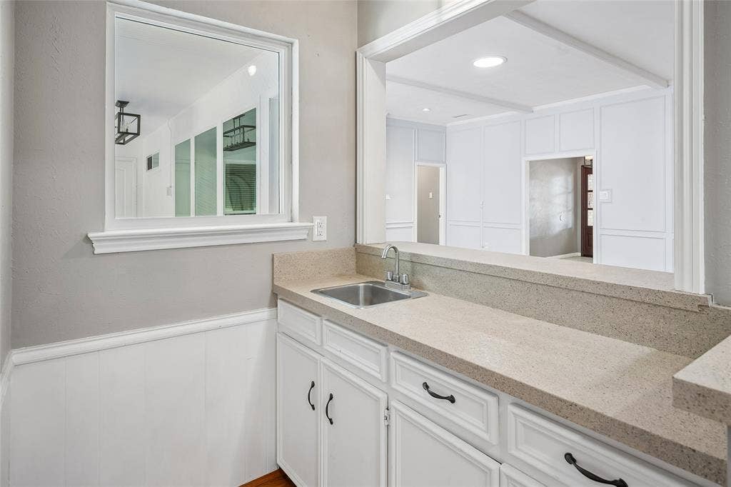 The wet bar can be entered from the family room and it serves both living areas.