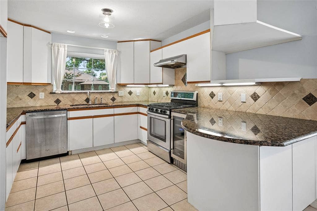 Updated cabinets and a charming window box over the sink