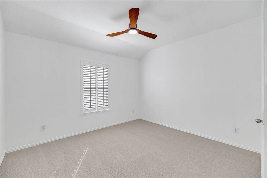 239 Glen Ridge Drive, Murphy, TX 75094 Carpeted flooring, white walls, window with plantation shutters, wood-finish ceiling fan with integrated lighting