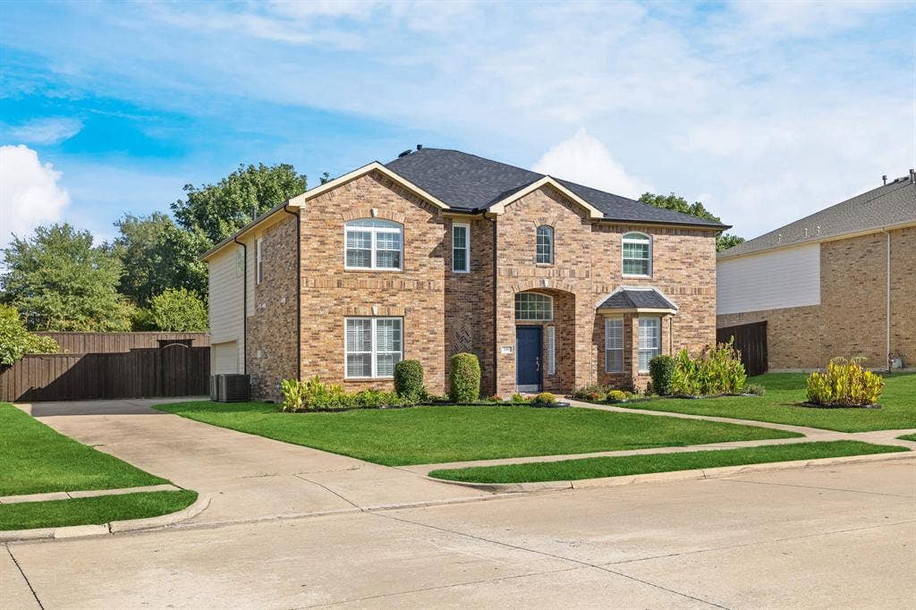 239 Glen Ridge Drive, Murphy, TX 75094 Brick exterior with a dark roof and white trim