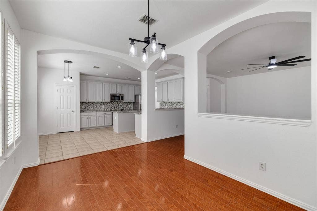 239 Glen Ridge Drive, Murphy, TX 75094 Hardwood flooring, arched doorways, window shutters, recessed lighting, and a modern ceiling fan