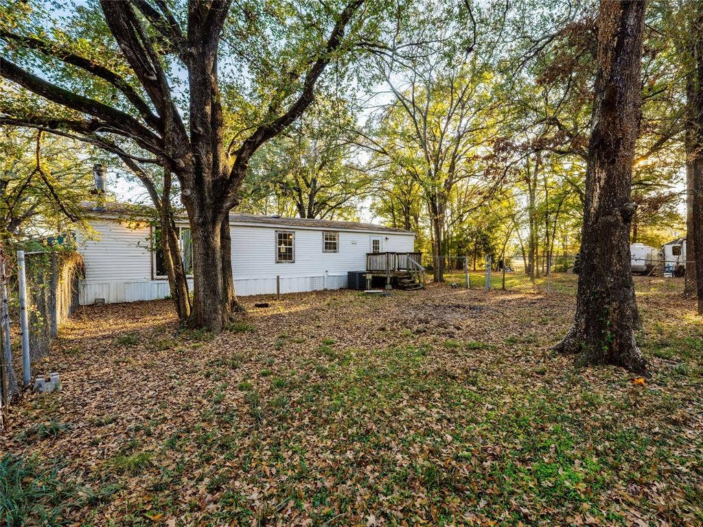 Spacious wooded lot with mature trees providing natural canopy coverage and abundant shade
