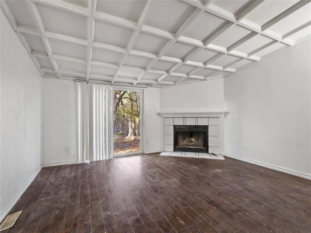 Coffered ceiling, wood-finish flooring, white brick fireplace, and sliding glass door