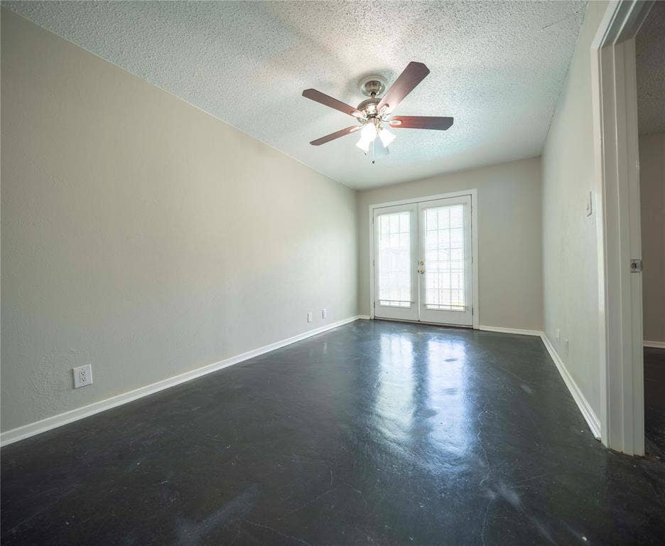 1717 N Locust Street, #1, Denton, TX 76201 Painted walls, dark polished flooring, ceiling fan with integrated lighting, and white French doors