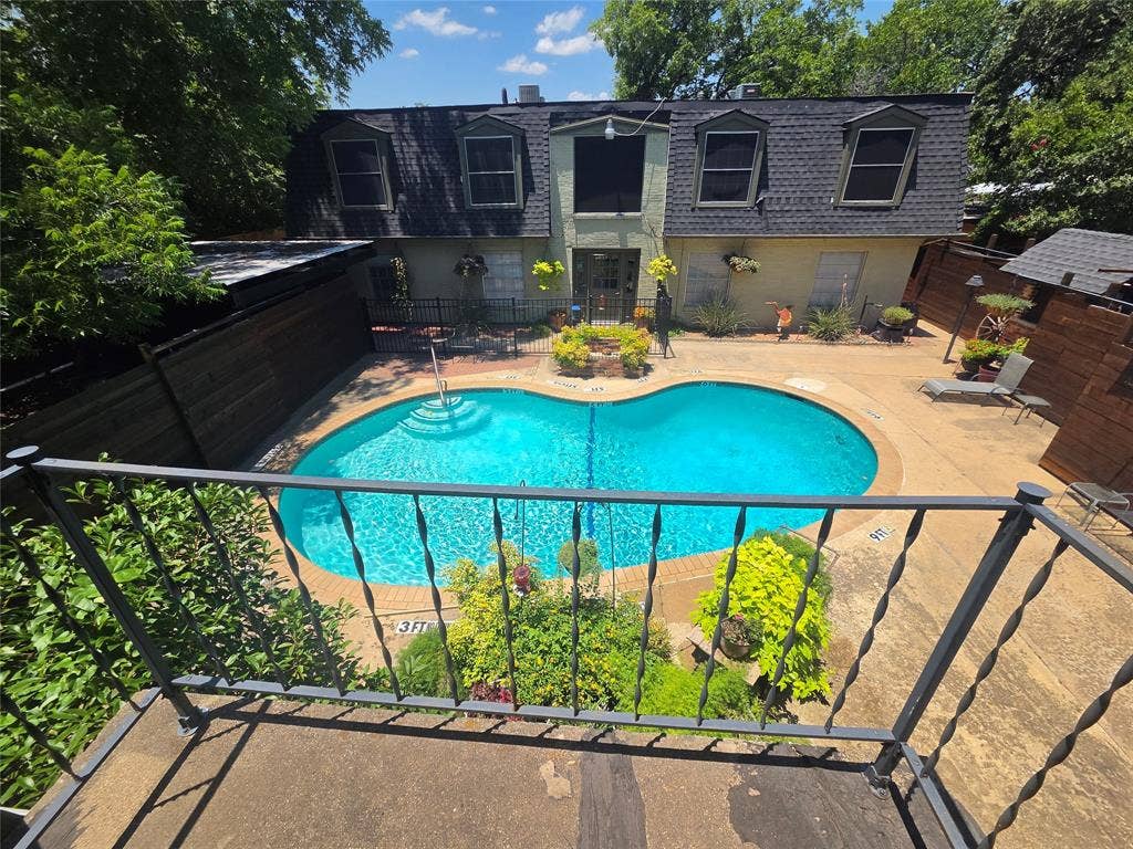 1717 N Locust Street, #1, Denton, TX 76201 Kidney-shaped swimming pool with integrated steps, surrounded by a concrete patio
