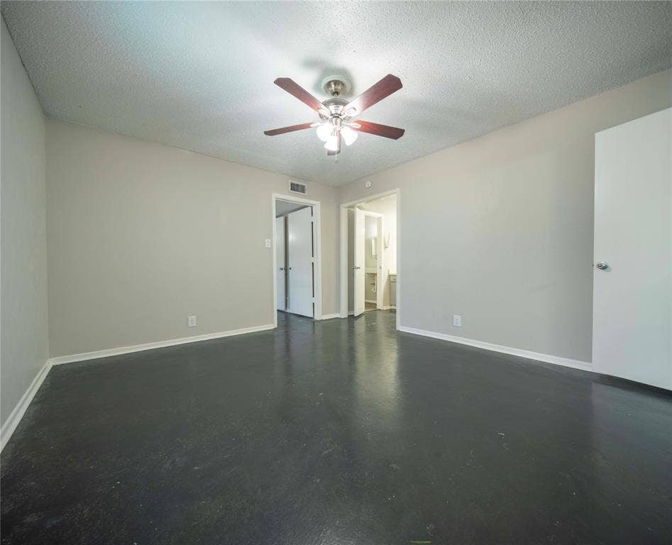 1717 N Locust Street, #1, Denton, TX 76201 Spacious room with dark flooring and light gray walls