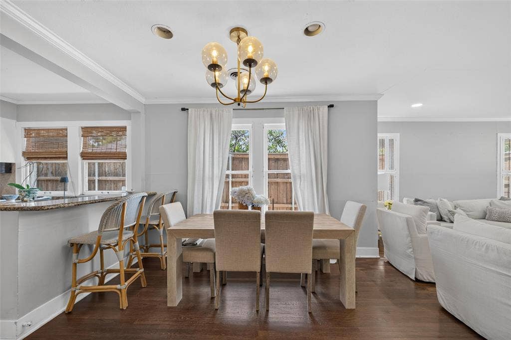 5630 Vanderbilt Avenue, Dallas, TX 75206 Recessed lighting, wood-finish flooring, gold-finish chandelier, crown molding, and a granite-finish breakfast bar