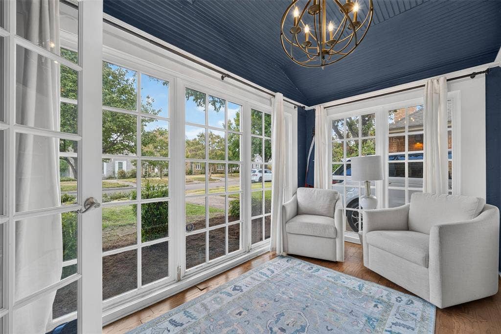 5630 Vanderbilt Avenue, Dallas, TX 75206 Wood-finish flooring, multiple paneled windows, vaulted ceiling, and an ornate chandelier