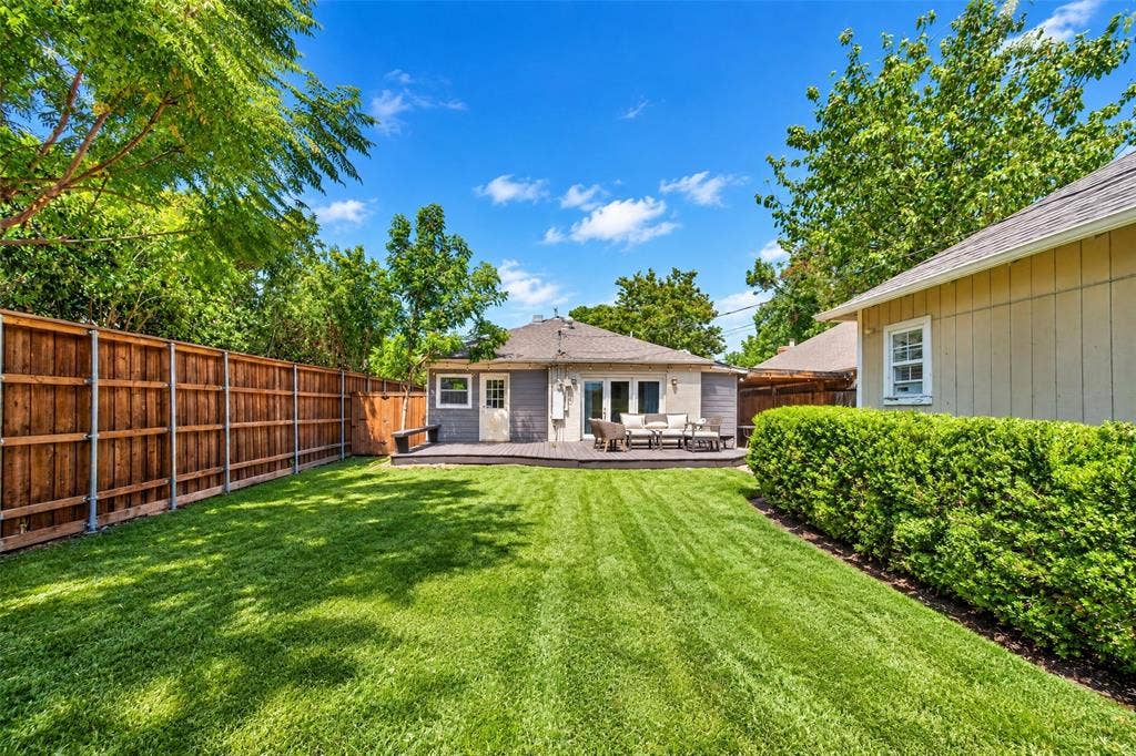 5630 Vanderbilt Avenue, Dallas, TX 75206 Expansive backyard featuring a manicured lawn, wood privacy fencing, and mature trees