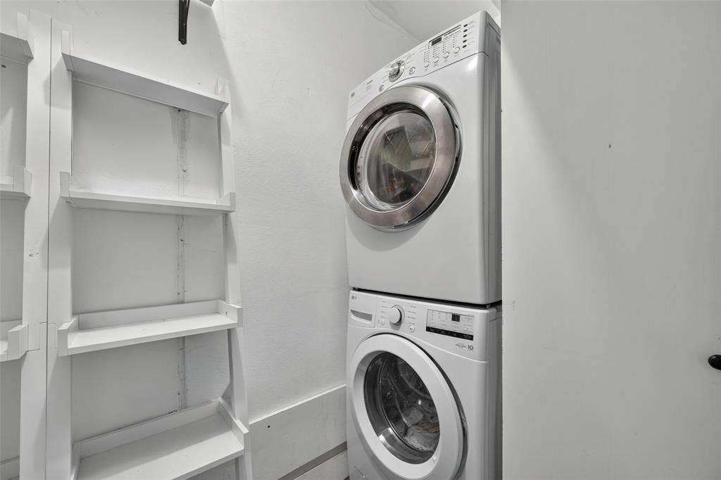 5630 Vanderbilt Avenue, Dallas, TX 75206 White stacked laundry appliances and white built-in shelving