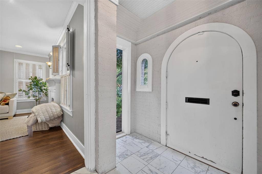 5630 Vanderbilt Avenue, Dallas, TX 75206 Arched entry door with black hardware, white tile flooring, and an arched window