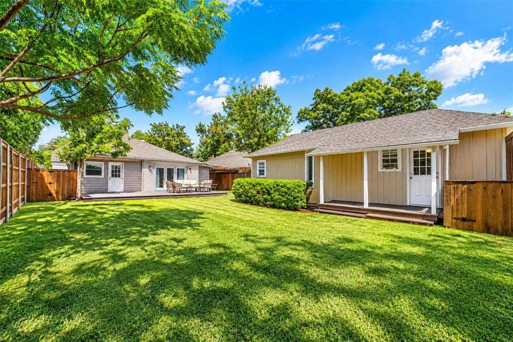 5630 Vanderbilt Avenue, Dallas, TX 75206 Expansive grassy lawn with a wood fence perimeter