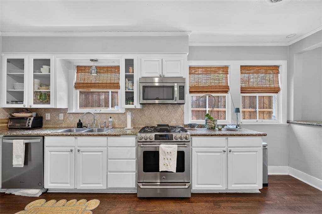 5630 Vanderbilt Avenue, Dallas, TX 75206 Kitchen featuring white cabinetry, stainless steel appliances, granite countertops, and wood-finish flooring