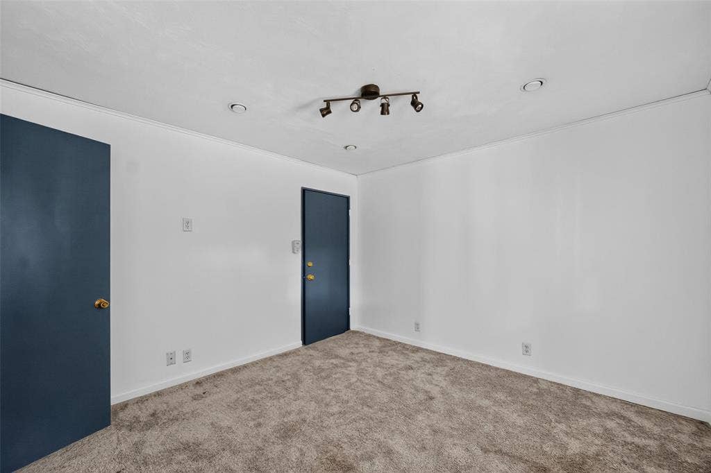 5630 Vanderbilt Avenue, Dallas, TX 75206 White walls with crown molding, track lighting, two recessed ceiling lights, and two doors