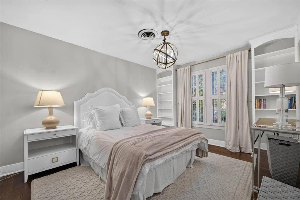 5630 Vanderbilt Avenue, Dallas, TX 75206 Hardwood flooring, built-in shelving, white window shutters, and a decorative ceiling light fixture
