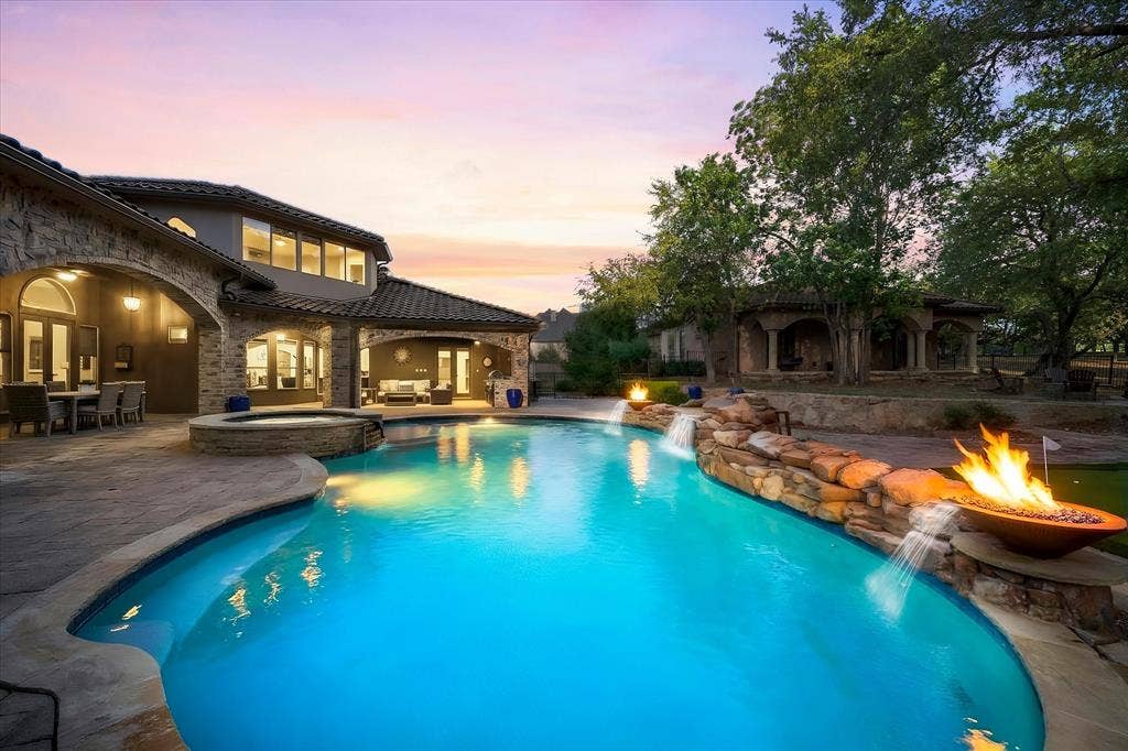 1739 Bison Meadow Lane, Heath, TX 75032 Oversized Pool, Raised Spa, Waterfall with two fire bowls & water features as well. Guest Residence in back ground.