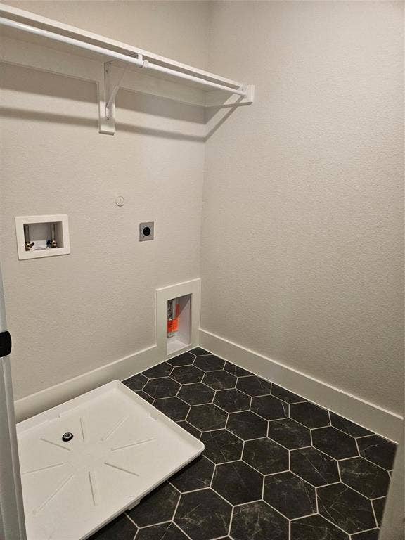 221 Chestnut Street, Celina, TX 75009 White shelf and hanging rod, textured white walls, utility hookups, and hexagonal floor tiling