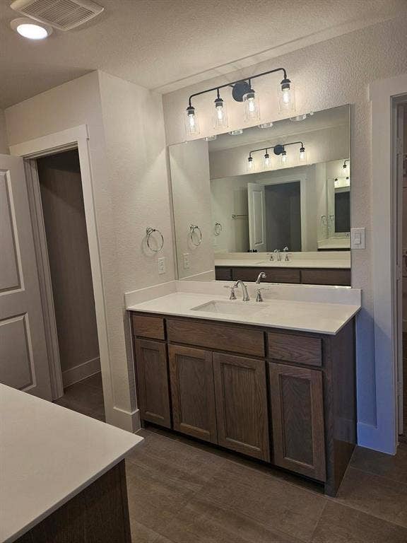 221 Chestnut Street, Celina, TX 75009 Dual wood-finish vanities with light-toned countertops and integrated sinks