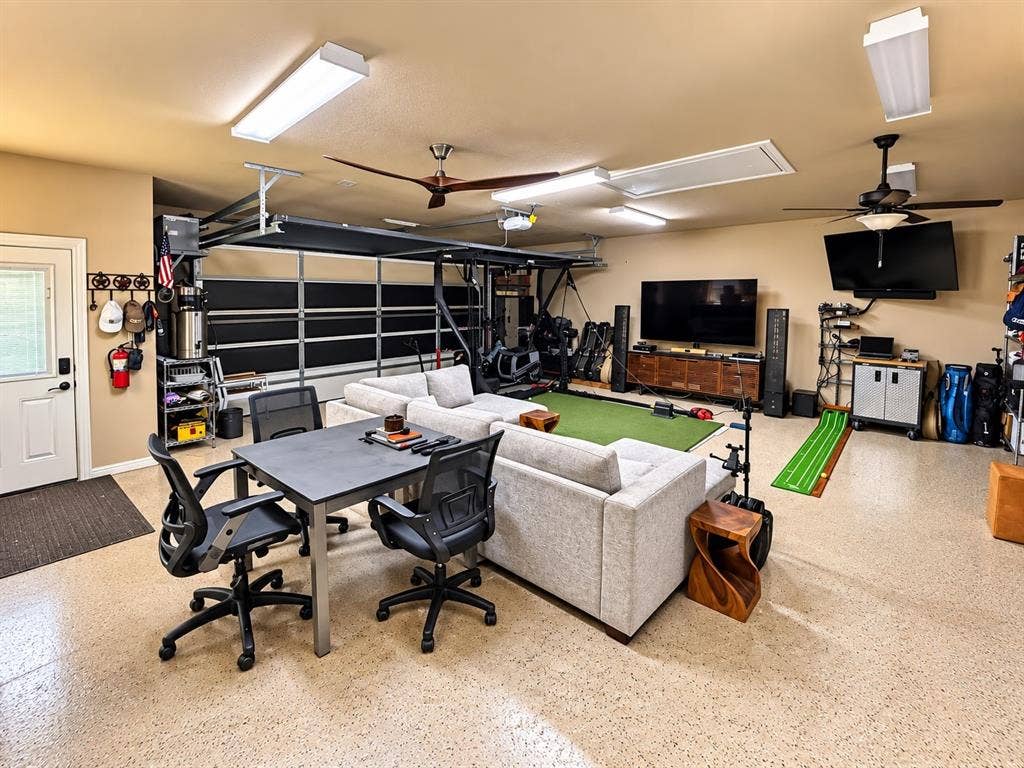 1729 Bent Tree Court, Granbury, TX 76049 Detached 2-car garage with epoxy flooring, half bathroom, screened garage door, and window AC unit