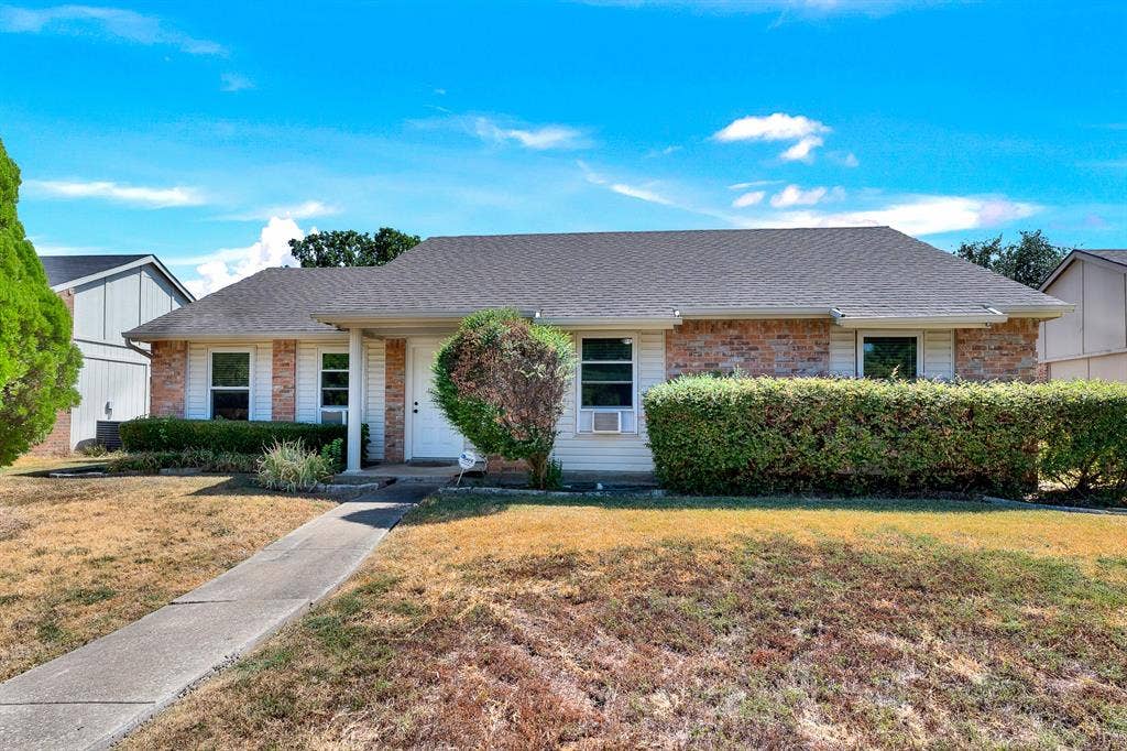 108 Kingsbridge Drive, Garland, TX 75040 Brick and siding exterior with a shingled roof