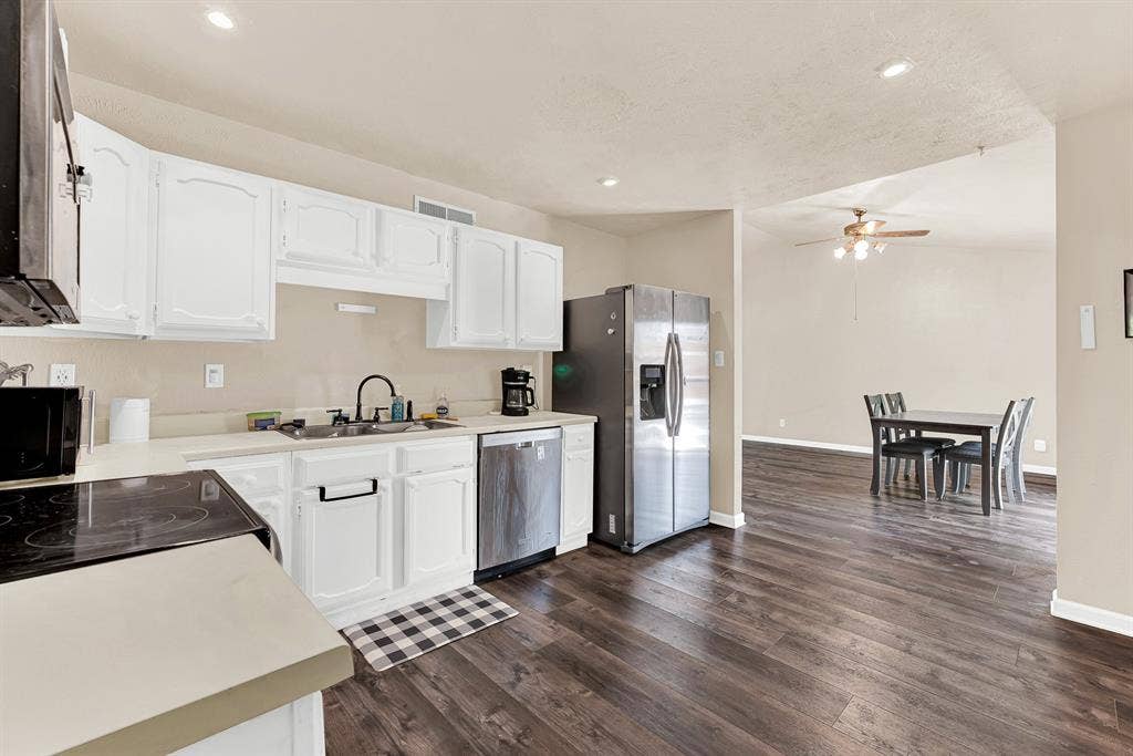 108 Kingsbridge Drive, Garland, TX 75040 Kitchen featuring white cabinetry, stainless steel appliances, and light-toned countertops