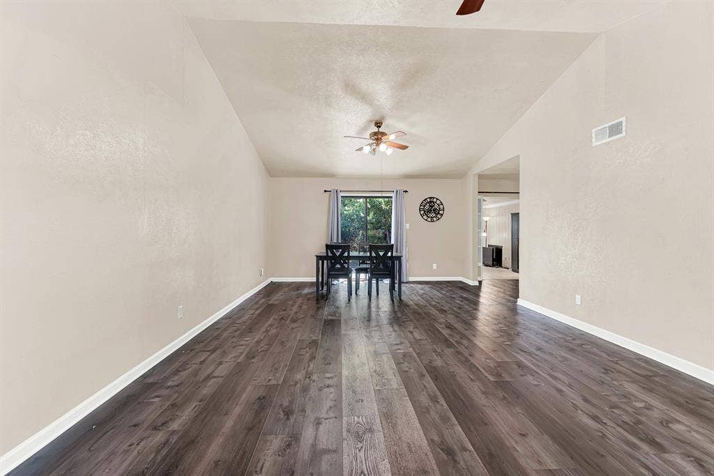 108 Kingsbridge Drive, Garland, TX 75040 Vaulted ceiling with a ceiling fan, wood-finish flooring, and natural light from exterior window