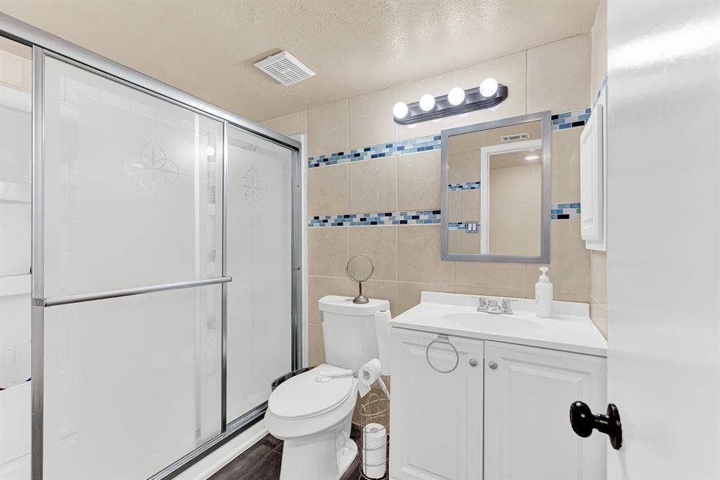 108 Kingsbridge Drive, Garland, TX 75040 Expansive backyard featuring mature trees, brick exterior, and a privacy fence