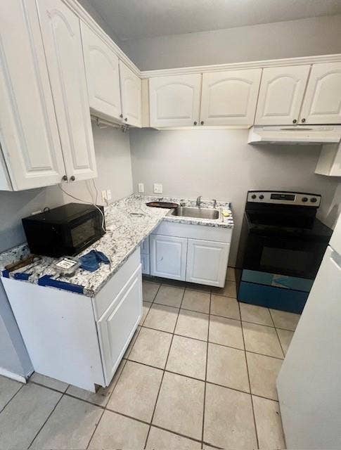 5205 Hudson Bend Road, Austin, TX 78734 White cabinetry with polished hardware, granite-style countertops, stainless steel sink, built-in range hood, and tile flooring