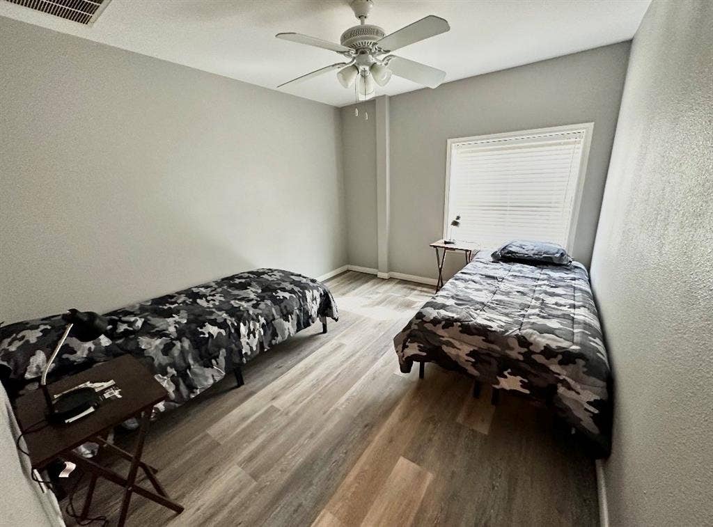 5205 Hudson Bend Road, Austin, TX 78734 Wood-finish flooring, ceiling fan, window with horizontal blinds, and neutral wall color