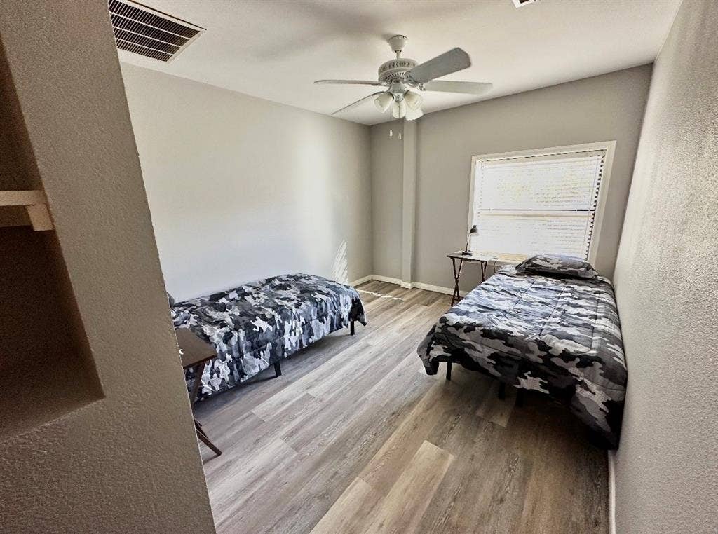 5205 Hudson Bend Road, Austin, TX 78734 Room with wood-finish flooring, a ceiling fan with integrated lighting, and a window with horizontal blinds