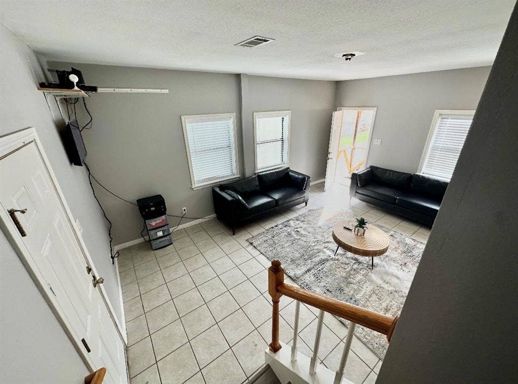 5205 Hudson Bend Road, Austin, TX 78734 Tiled flooring throughout, multiple windows with blinds, and white trim accents