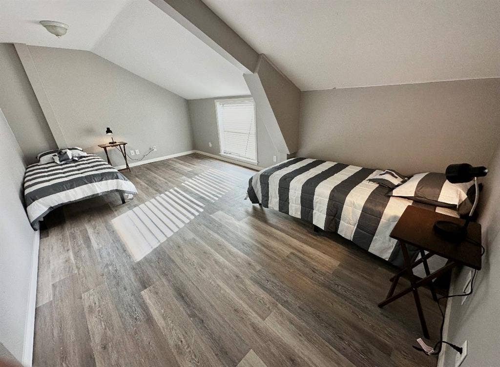 5205 Hudson Bend Road, Austin, TX 78734 Sloped ceilings, wood-finish flooring, and a window with blinds