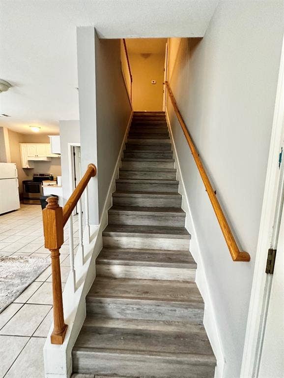 5205 Hudson Bend Road, Austin, TX 78734 Staircase featuring wood-finish treads and risers, wood newel post, and wood handrails