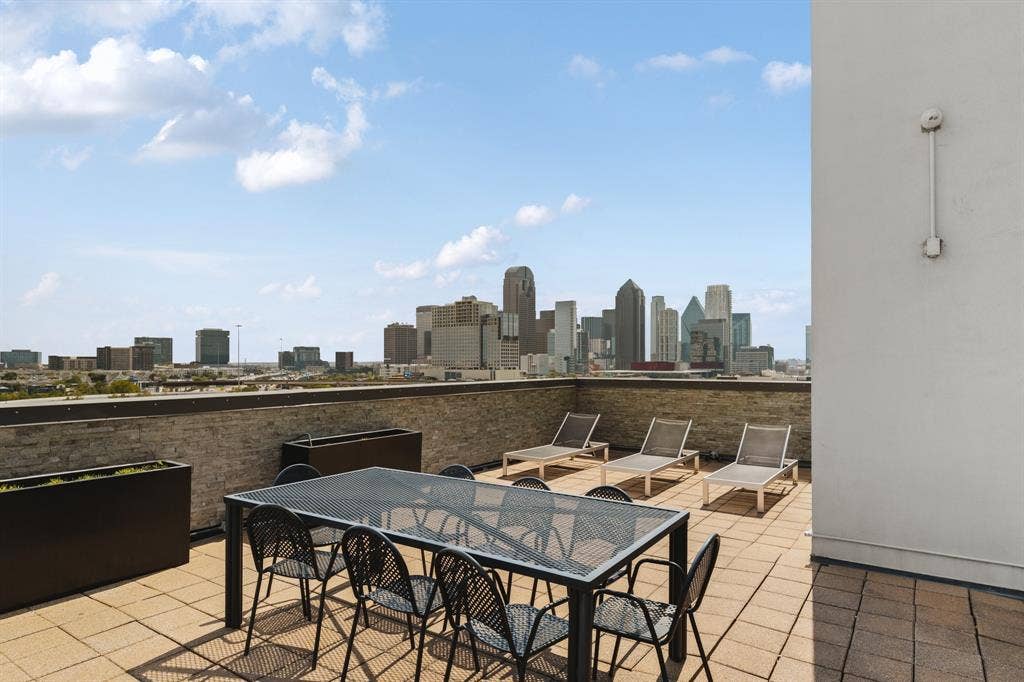 Rooftop terrace with paver flooring and cityscape backdrop