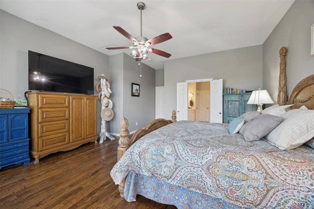 1000 Fenwick Lane, Forney, TX 75126 Wood-finish flooring, ceiling fan with integrated lighting, and a double-door entry to an additional space