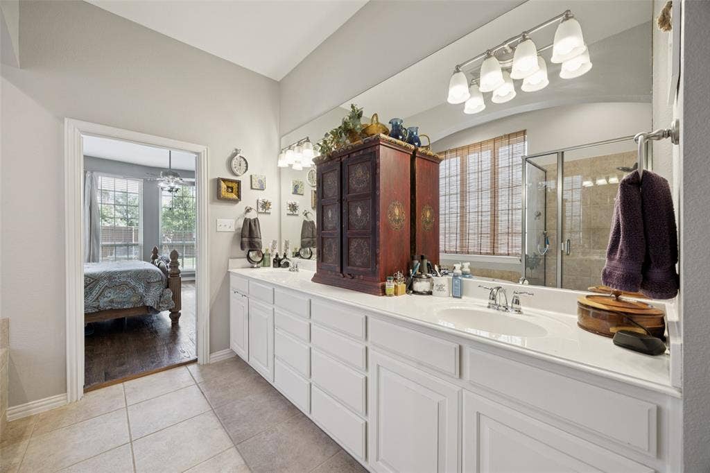 1000 Fenwick Lane, Forney, TX 75126 Dual vanity with integrated sinks, extensive counter space, and tiled flooring
