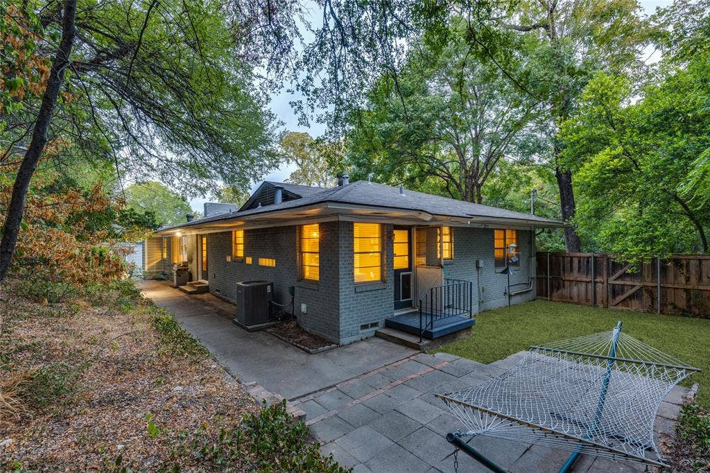 737 N Hampton Road, Dallas, TX 75208 Broad eaves, low rooflines and mature trees reinforce the home’s strong relationship to its site.