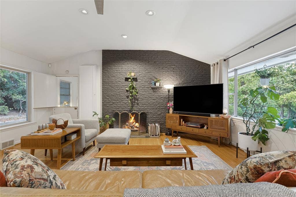 737 N Hampton Road, Dallas, TX 75208 Hardwood floors and a dramatic gas fireplace anchor the vaulted Living Room.