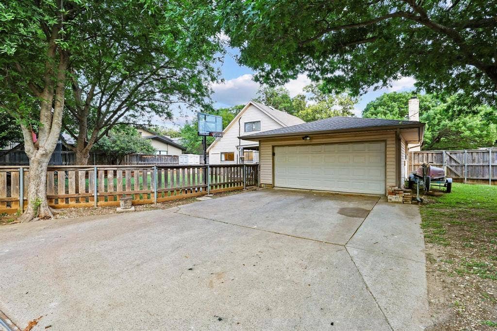 The rear facing garage has a large driveway and alley access with an electric privacy gate for added security