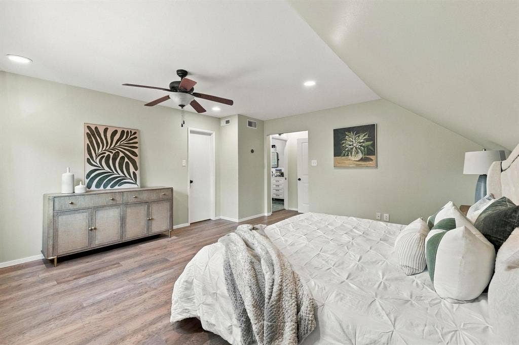 Large primary bedroom with wood floors