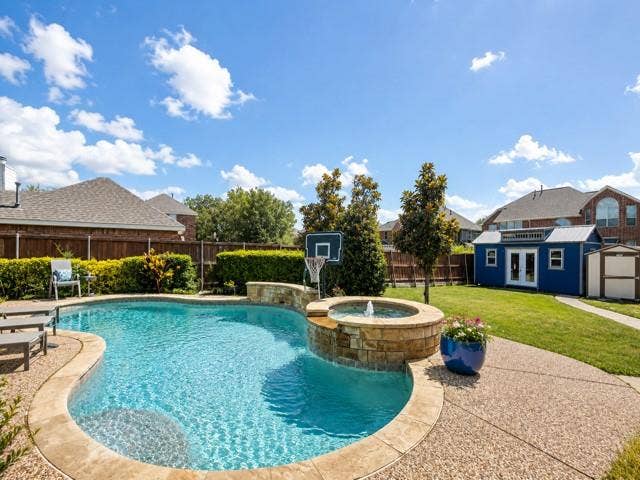 10201 Evergreen Drive, Rowlett, TX 75089 Oversized deep lot with large grassy area, 3 storage buildings, plus pool/spa and a long driveway with gate.