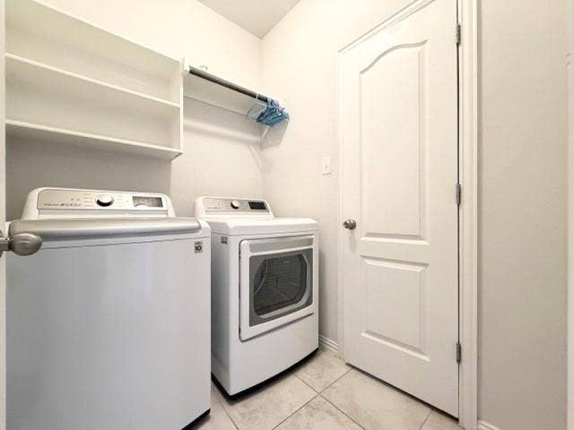 5609 Meritage Street, McKinney, TX 75070 Laundry area featuring tile flooring, built-in shelving, and a garment rod