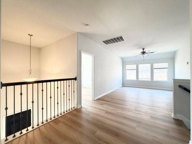 5609 Meritage Street, McKinney, TX 75070 Spacious upper-level landing featuring wood-finish flooring, a contemporary ceiling fan, and multiple windows