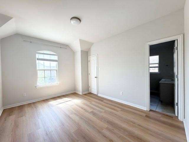 5609 Meritage Street, McKinney, TX 75070 Wood-finish flooring, a ceiling-mounted light fixture, and an arched window