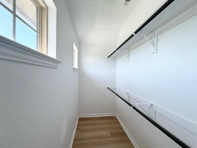 5609 Meritage Street, McKinney, TX 75070 Wood-finish flooring, white walls, and built-in closet rods with shelving