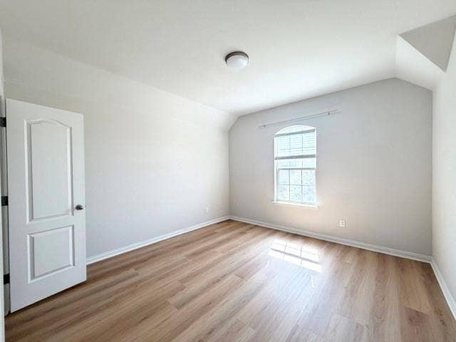 5609 Meritage Street, McKinney, TX 75070 Wood-finish flooring, arched window, recessed window blinds, neutral wall paint, and overhead flush-mount lighting
